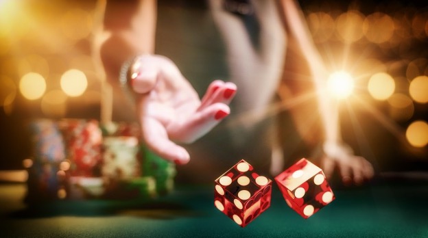 Action shot of dice being thrown, illustrating uncertainty in Polymarket investing